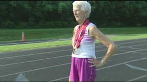 elderly lady wearing a race walking medal around her neck.