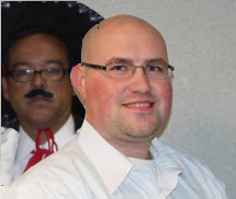 Picture of Scott with George, wearing a mariachi hat & fake mustache behind me