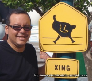 Picture of George by a "Chicken Crossing" sign at DisneyLand