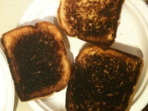 Three burned grilled cheese sandwiches.