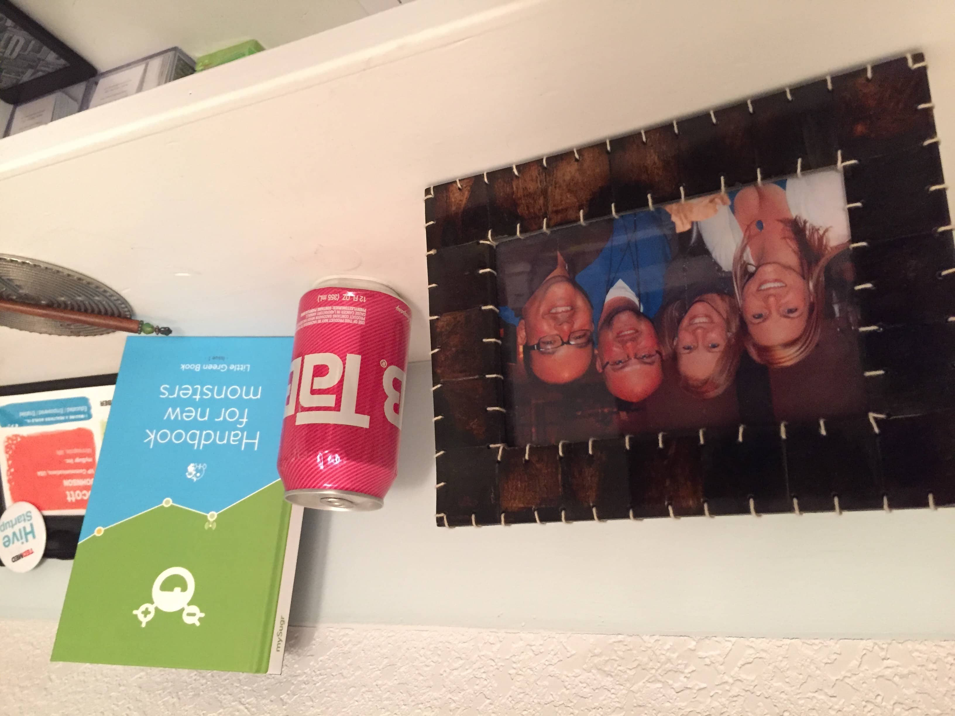 Picture of Kerri, Christel, Scott, George on Scott's bookshelf