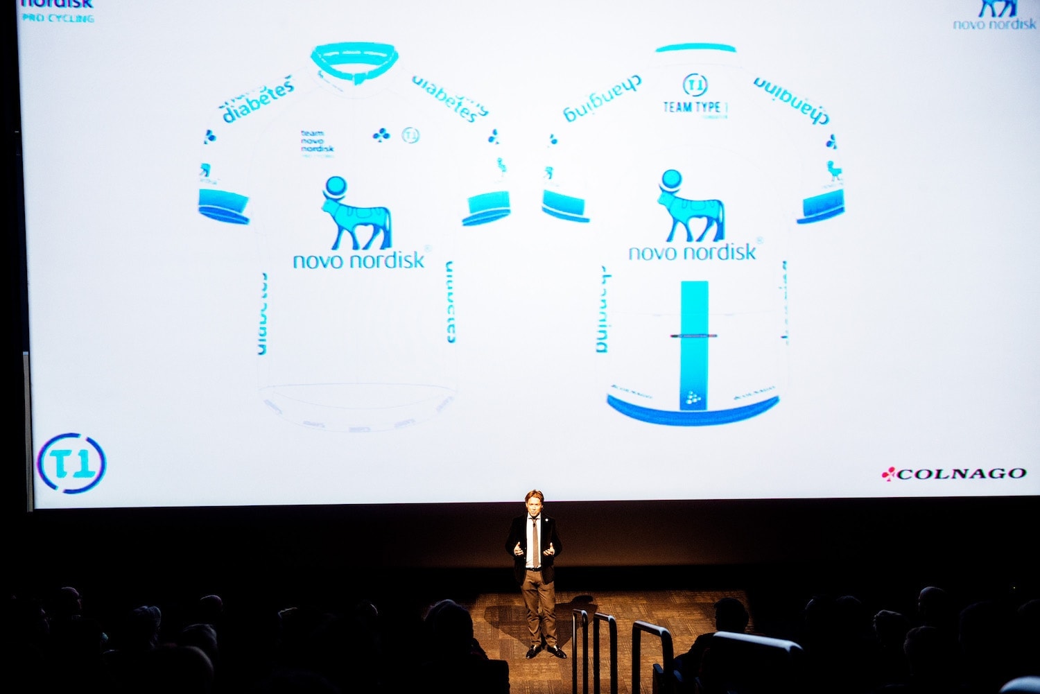 Phil Southerland on stage with a large image of the new Team Novo Nordisk jersey displayed above