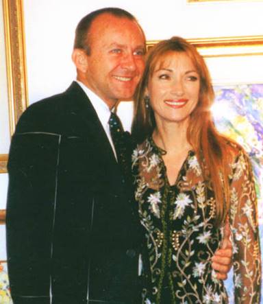 John standing next to Jane Seymour as they host a party together.